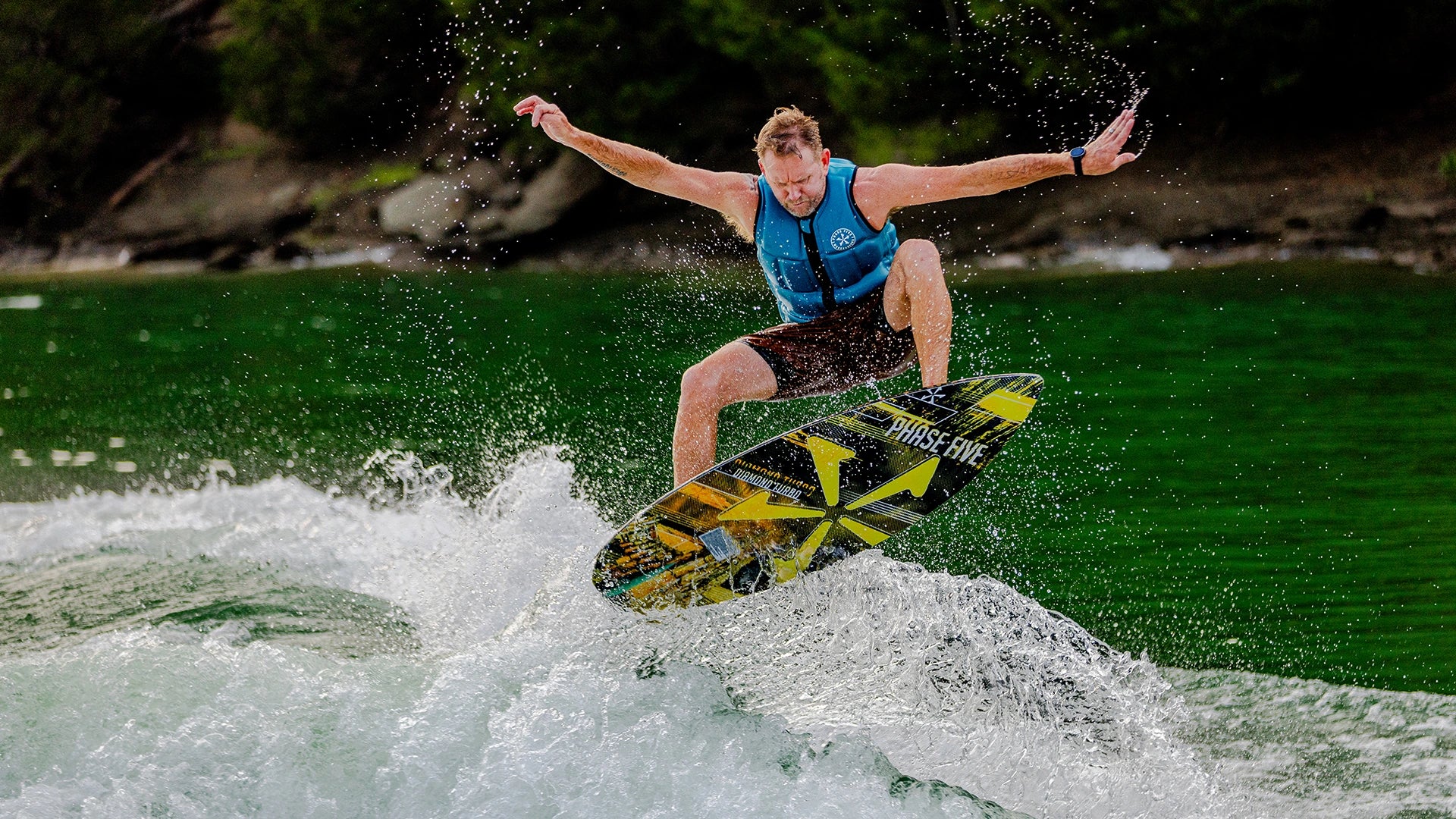 Phase Five rider jumping a Limited Edition skim board with gold graphics