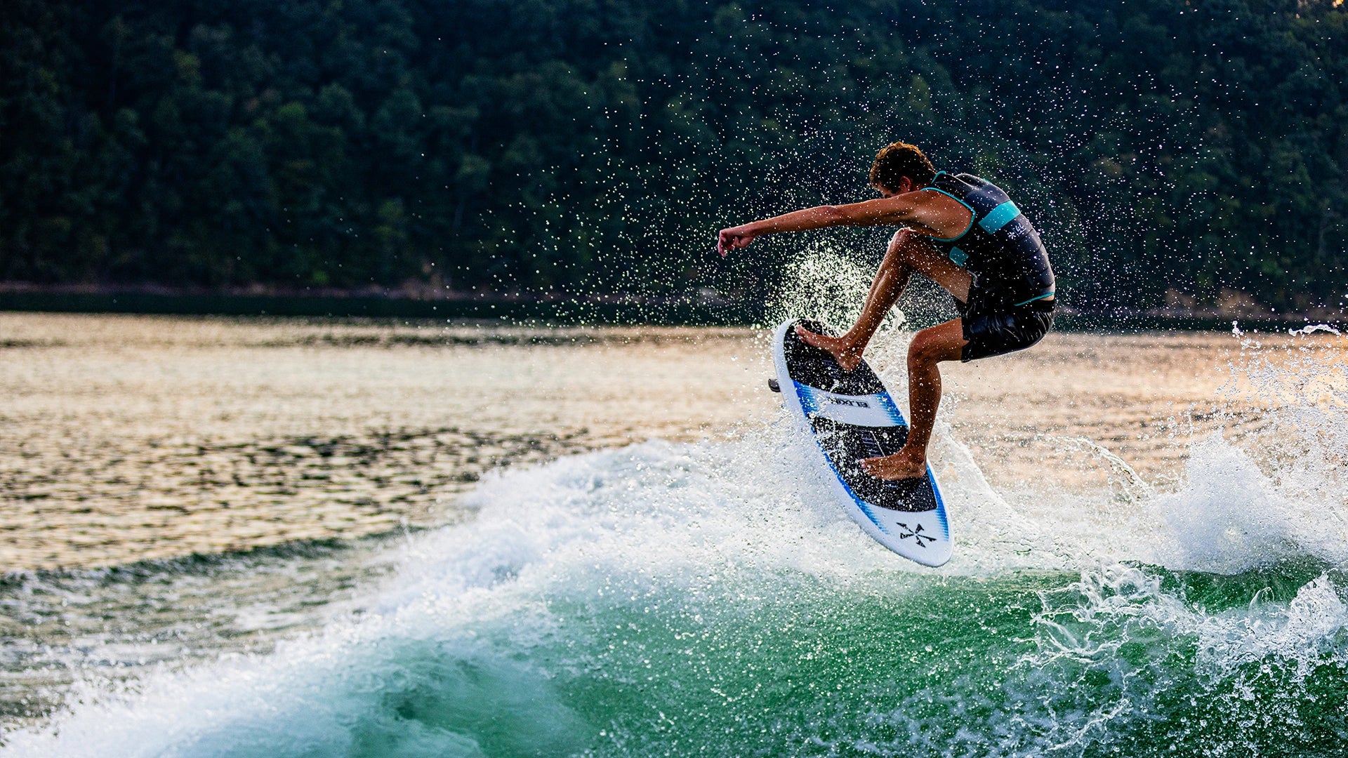 Phase Five rider airborne on the Elixir wakesurf board