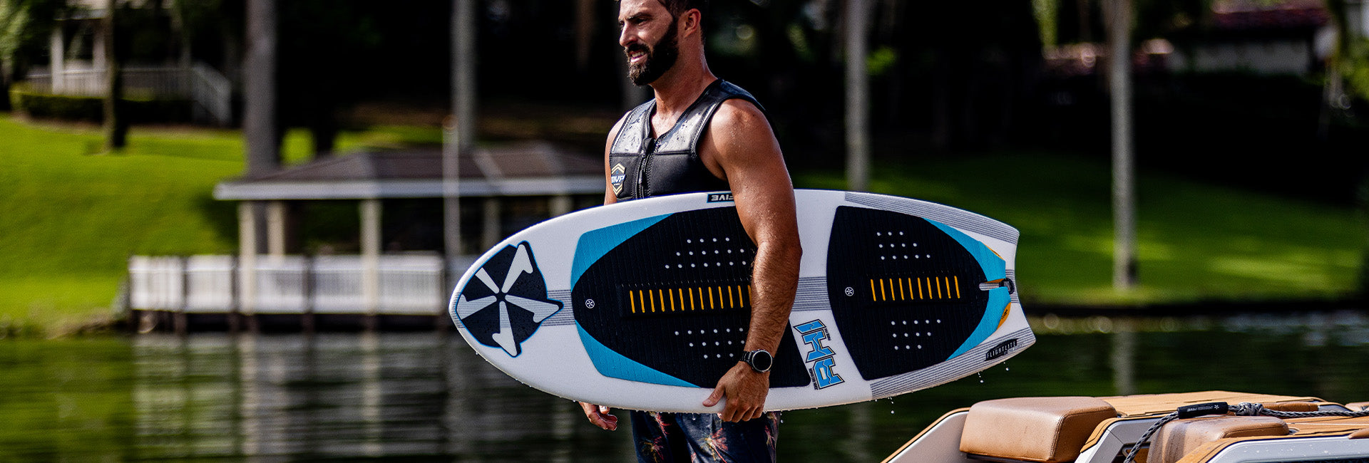 John Akerman holding a Phase Five wakesurf board