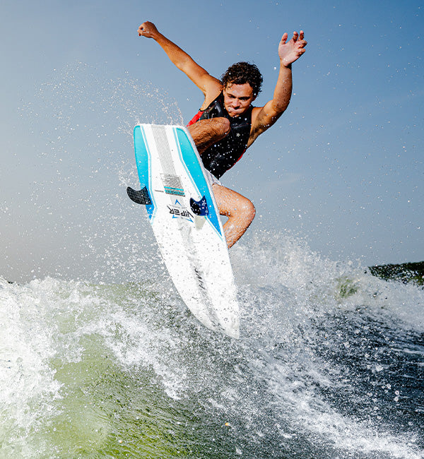 Sammy Goncalves wakesurfing on a Phase Five board